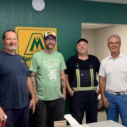 Four Mercer Fuels staff members together inside the office.