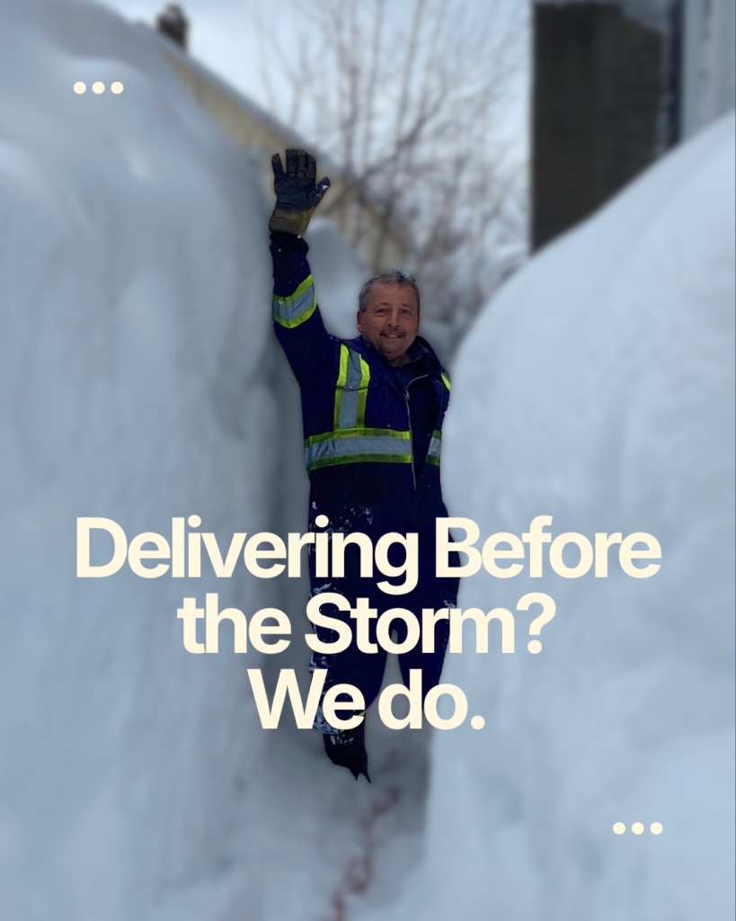 Mercer Fuels heating oil delivery technician walking through deep snow during winter storm Cape Breton NS